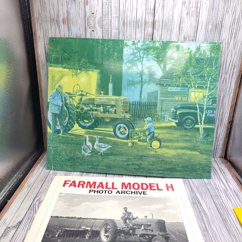 Farmall metal sign and Farmall photo archive book